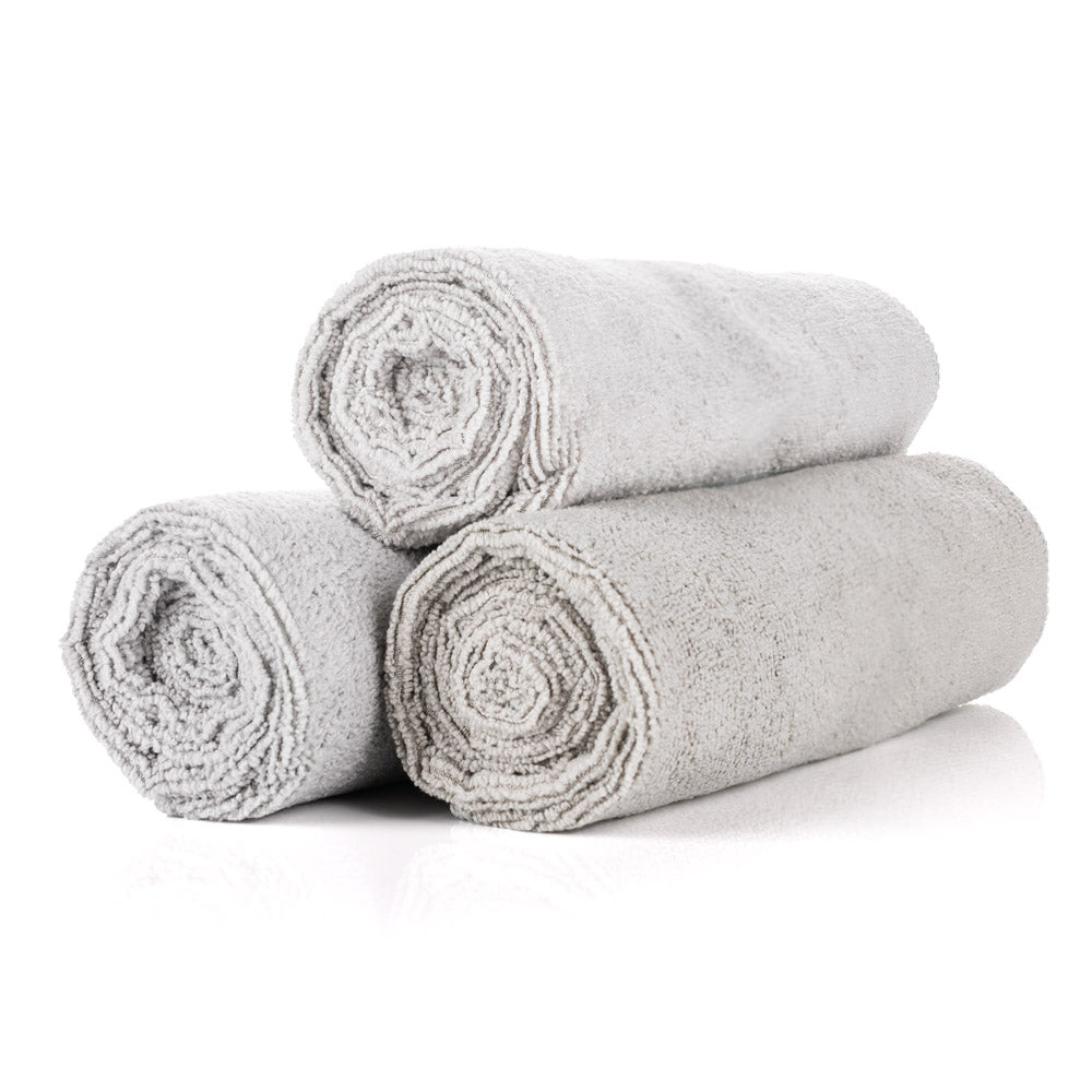 3 ice grey towels rolled up